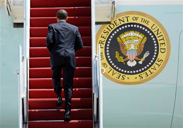 President Obama heads up the stairs of Air Force One
